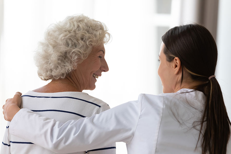 Doctor helping an elderly woman